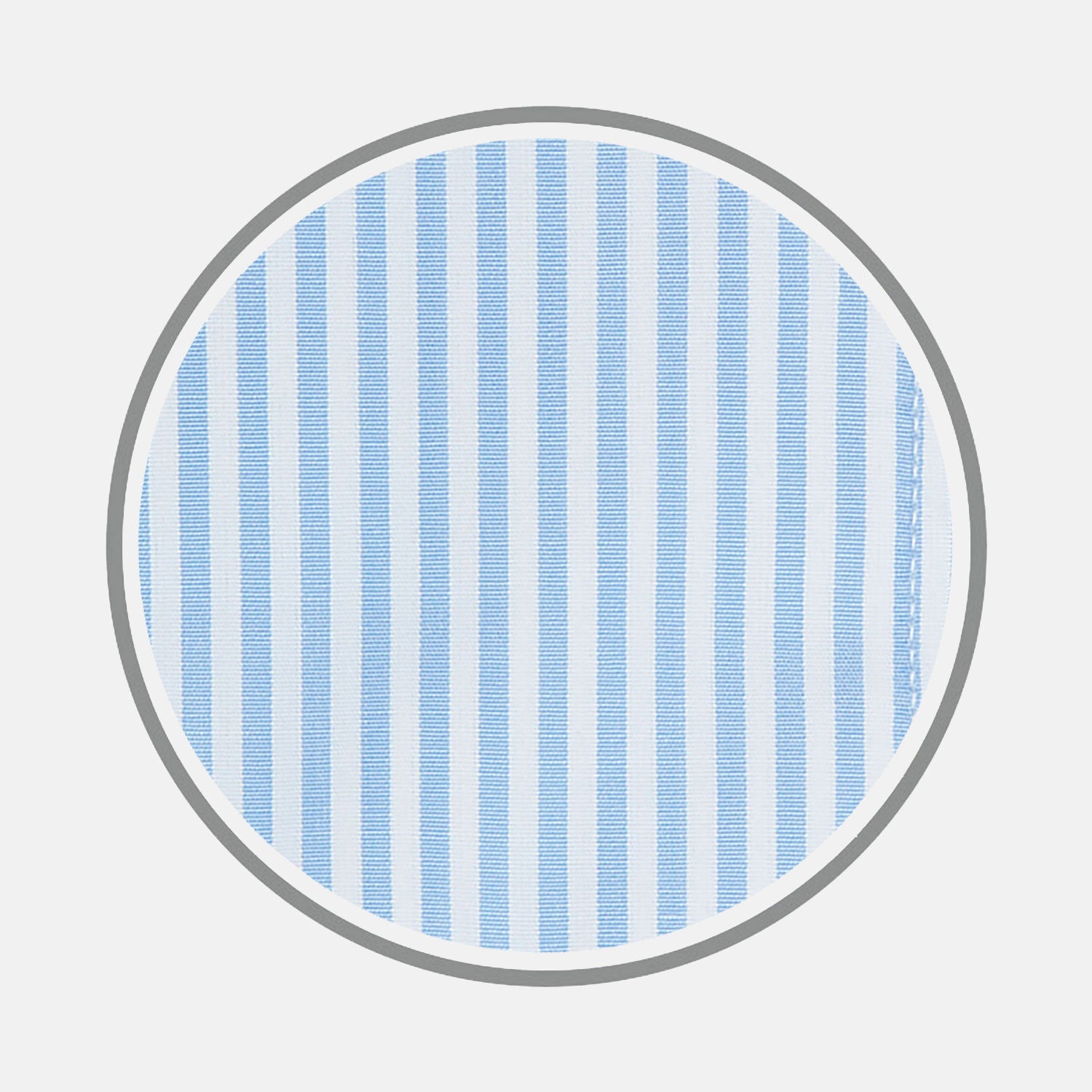 View 1 of product A close-up of Turnbull & Asser’s Light Blue Bengal Stripe Cotton Fabric shows its light blue and white vertical stripes pattern inside a gray circular frame on a white background.