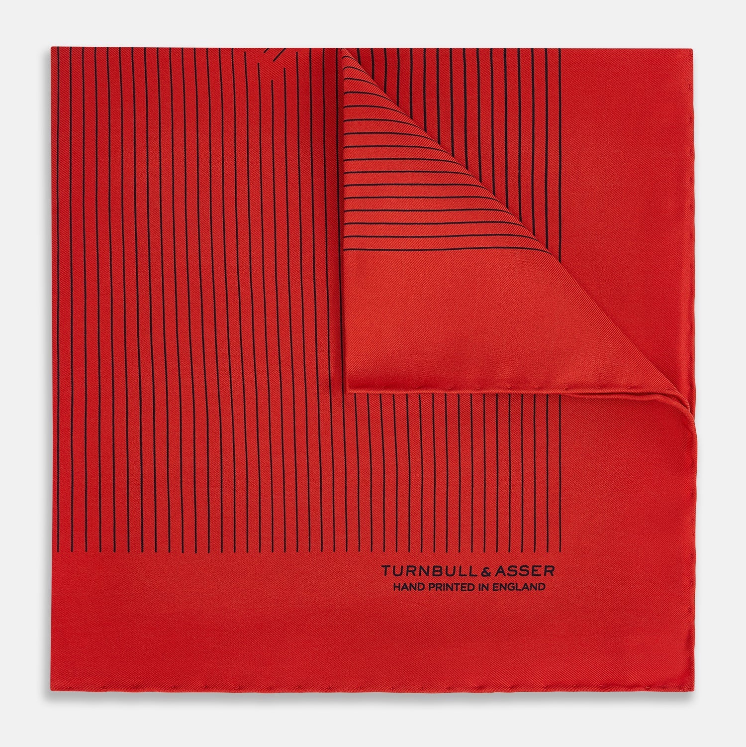 View 1 of product The Red Stripe Silk Pocket Square by Turnbull & Asser features thin black vertical lines and the brand signature in black on one corner, with a neatly folded edge for a touch of classic British style.