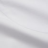 View 11 of product A person with curly hair wears the Turnbull and The Deck White Cotton Minimalist Shirt by Turnbull & Asser, paired with pants. Posed against a plain background, their minimalist silhouette is highlighted in this black and white image.