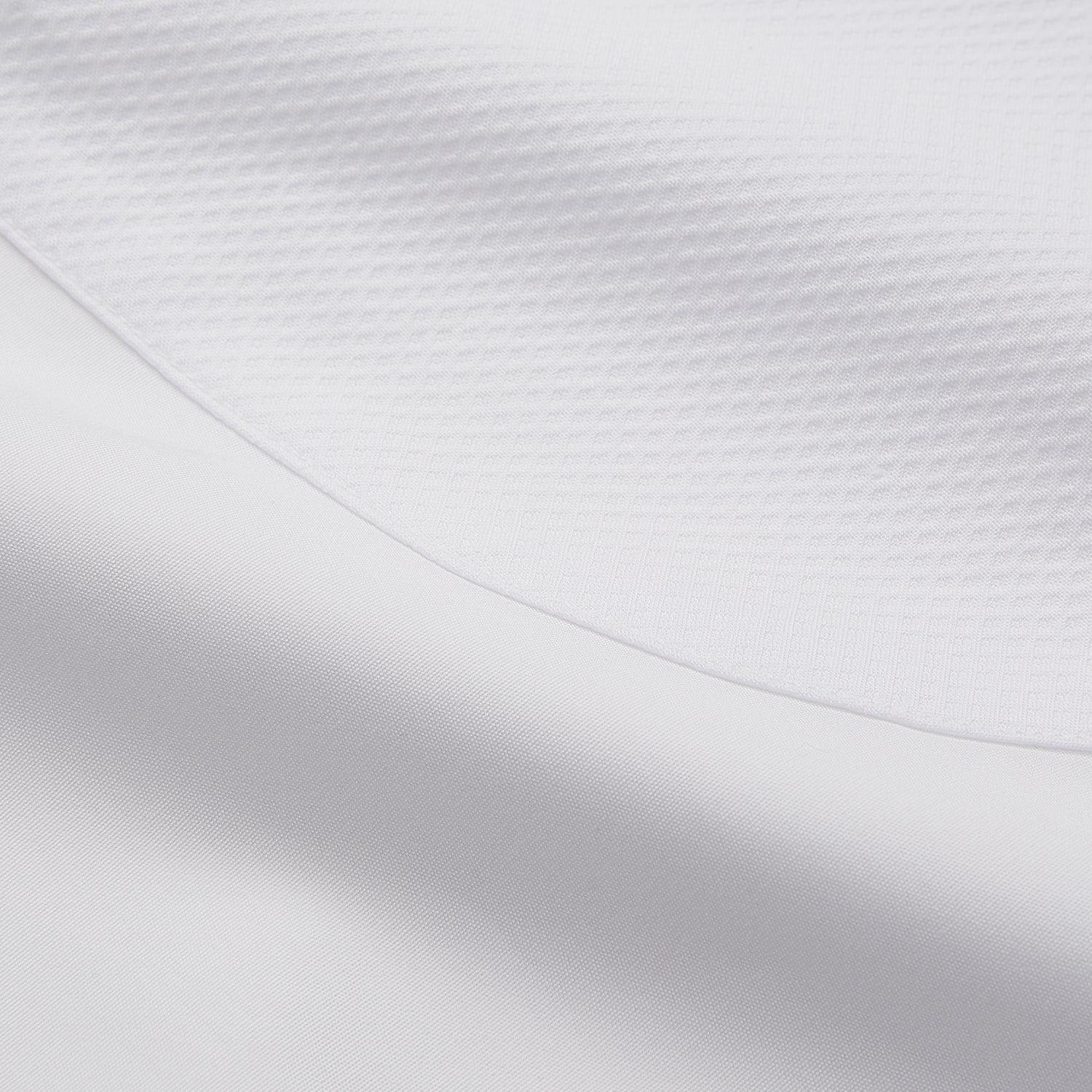 View 11 of product A person with curly hair wears the Turnbull and The Deck White Cotton Minimalist Shirt by Turnbull & Asser, paired with pants. Posed against a plain background, their minimalist silhouette is highlighted in this black and white image.