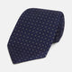 The Turnbull & Asser Navy and Grey Circle Silk Tie, featuring a refined pattern of evenly spaced circles, is elegantly displayed rolled up on a white background—an excellent option for modern office wear.