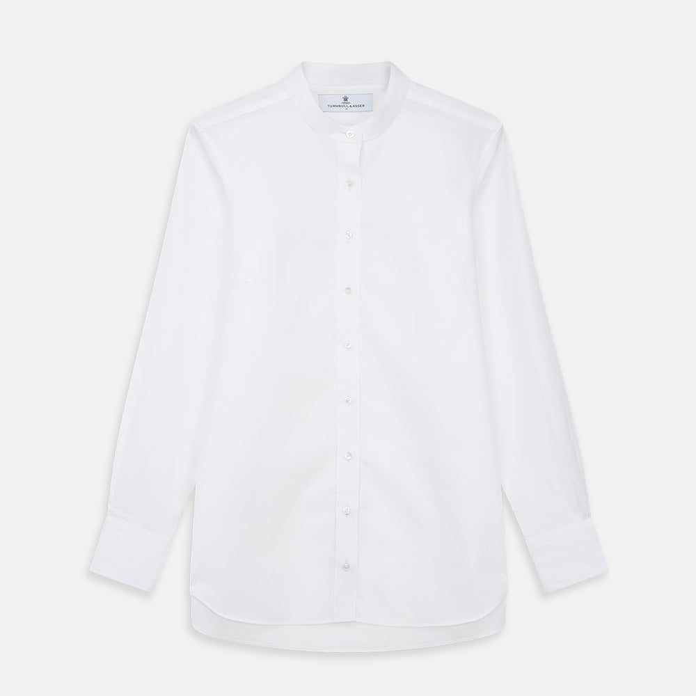 The White Cotton Lauren Shirt by Turnbull & Asser, featuring a stand collar, button-down front, and elongated body, is laid flat on a plain white background.