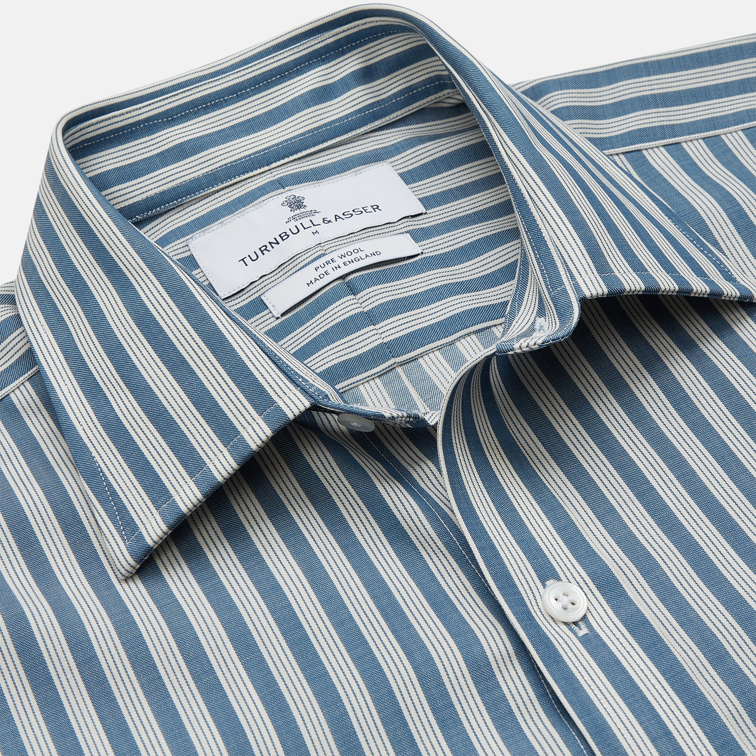View 2 of product Turnbull & Asser’s Pale Blue Multi Stripe Weekend Fit Wool Shirt features a Derby collar, 1-button cuffs, and a chest pocket—ideal for casual layering. Shown laid flat on a white background for easy styling.