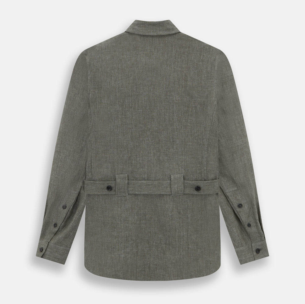 The Olive Linen Holland Shacket by Turnbull & Asser is a lightweight olive button-up jacket in Irish linen with a collar, two front pockets, one chest pocket, and slanted hem pockets—ideal outerwear shown on a plain white background.