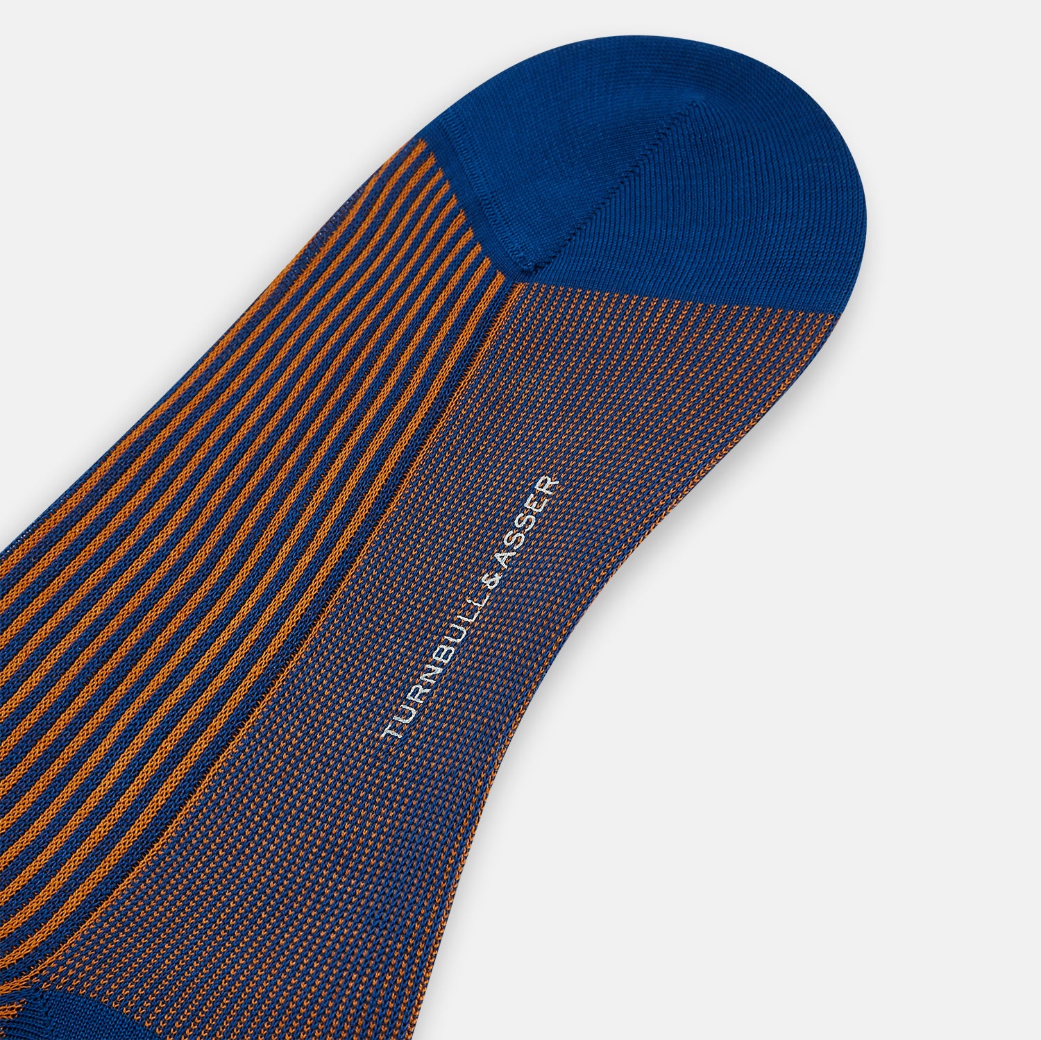 View 3 of product The Turnbull & Asser Royal Blue/Orange Thin Striped Long Sock is a knee-high, over-the-calf sock in mercerised Egyptian cotton, featuring vertical orange and dark blue stripes with blue cuff, heel, and toe. Displayed on a white background.
