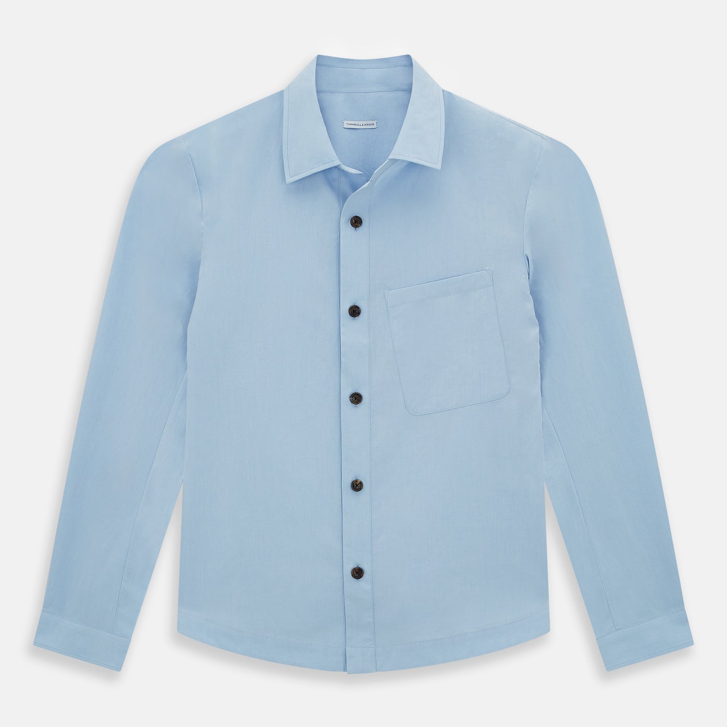 View 1 of product The Blue Hyde Overshirt by Turnbull & Asser features a light blue hue, long sleeves, a button-up front, and a single chest pocket. Crafted from sanforised cotton and shown laid flat on a white background.