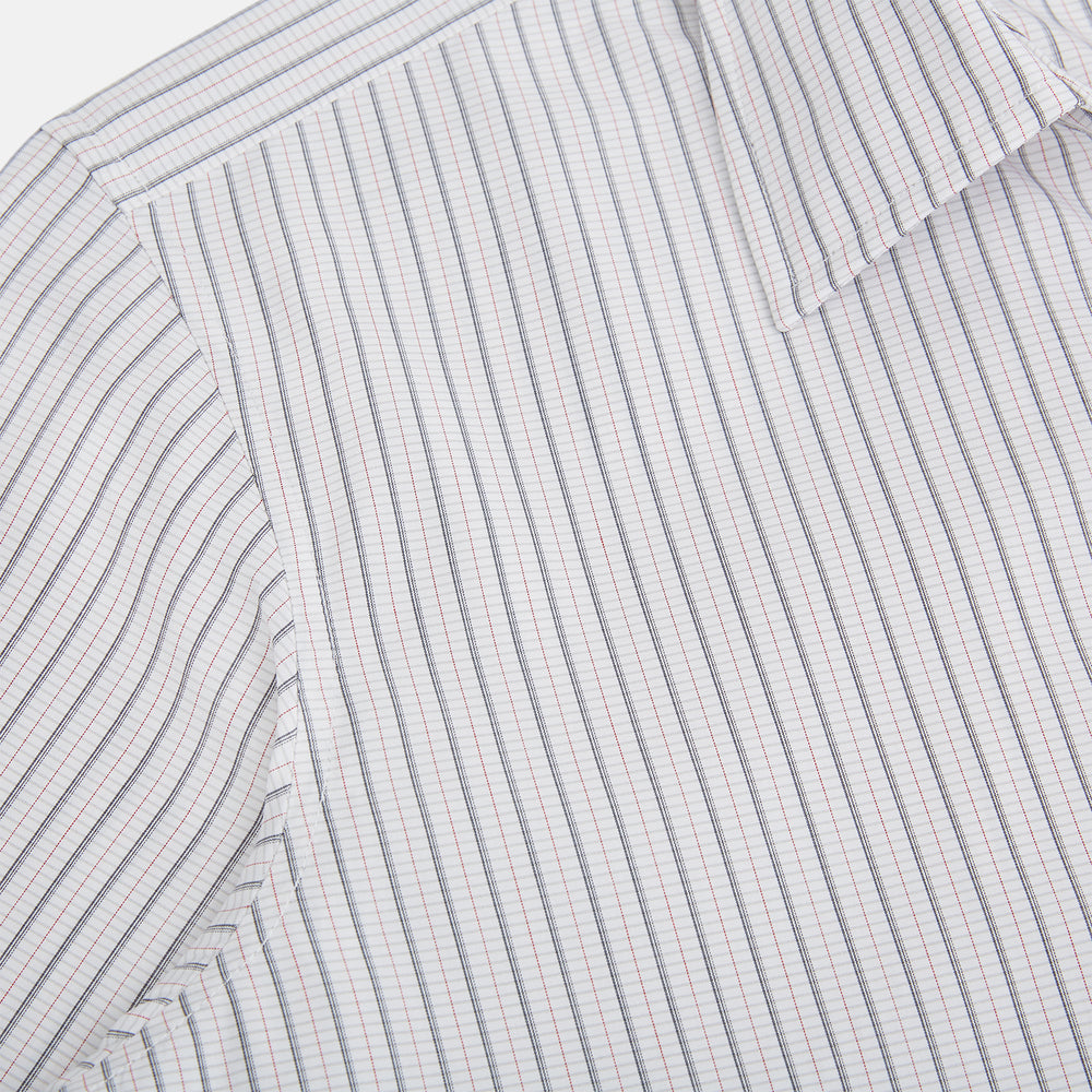 A red and navy graph check Westminster shirt by Turnbull & Asser with a formal collar and tailored fit, featuring a button-up front and buttoned cuffs, laid flat on a white background.