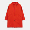 View 2 of product Wearing the Turnbull & Asser Red Walter Sealup Parka with Detachable Liner, black pants, and white sneakers, a person stands in profile against a plain light background—perfect for travel.
