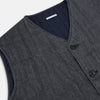 View 2 of product The Turnbull & Asser Ash Quilted Linen Herringbone Waistcoat is sleeveless and dark gray with a V-neck, two zippered side pockets, and a small chest pocket, shown on a plain white background.