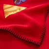 View 4 of product The Turnbull & Asser Red Applique Hand Stitched Lambswool Blanket features black-stitched edges and handsewn tie silk patches, including a yellow triangle and plaid triangle arranged to form a stylized fish.