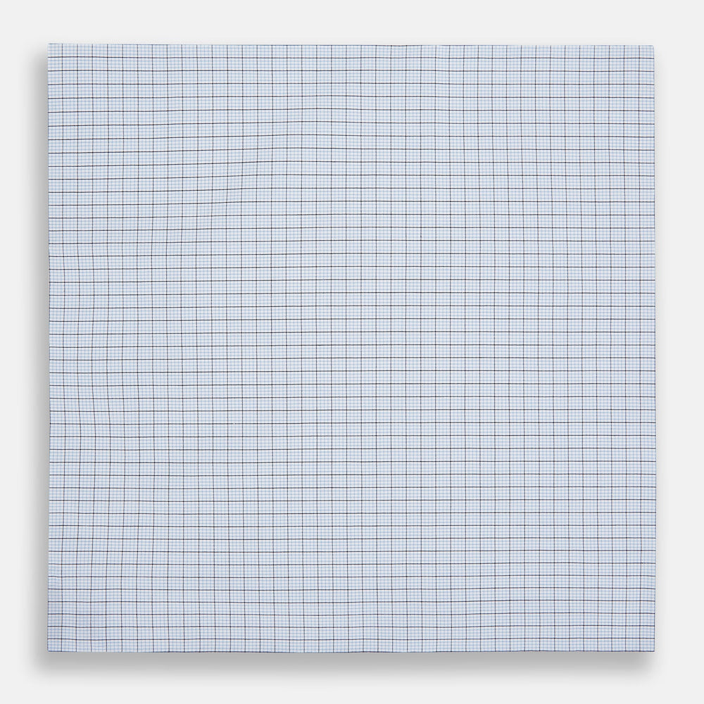 The Hand Rolled Blue Multi Graph Check Handkerchief by Turnbull & Asser features a white base with a blue grid and bold lines, resembling elegant graph paper, set against a clean white background.
