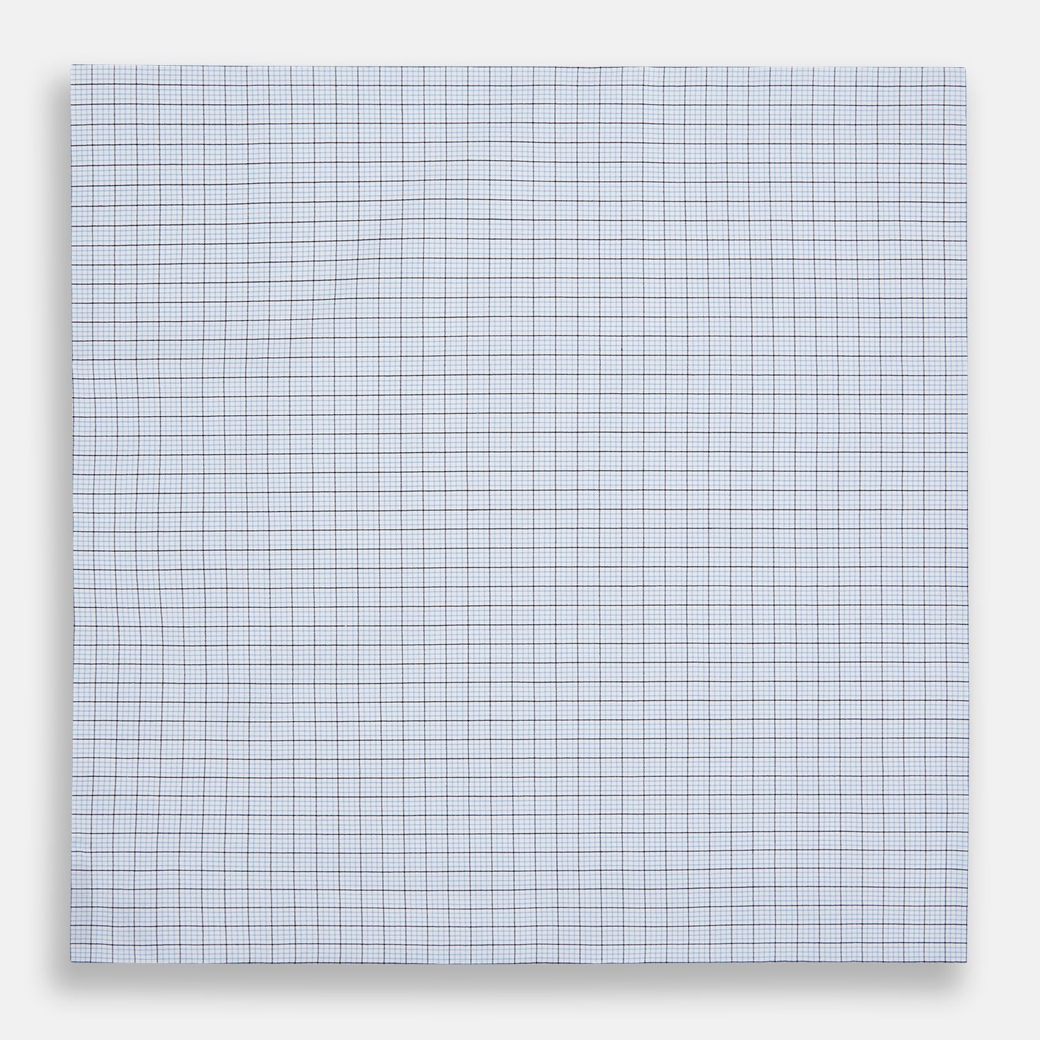 View 3 of product The Hand Rolled Blue Multi Graph Check Handkerchief by Turnbull & Asser features a white base with a blue grid and bold lines, resembling elegant graph paper, set against a clean white background.