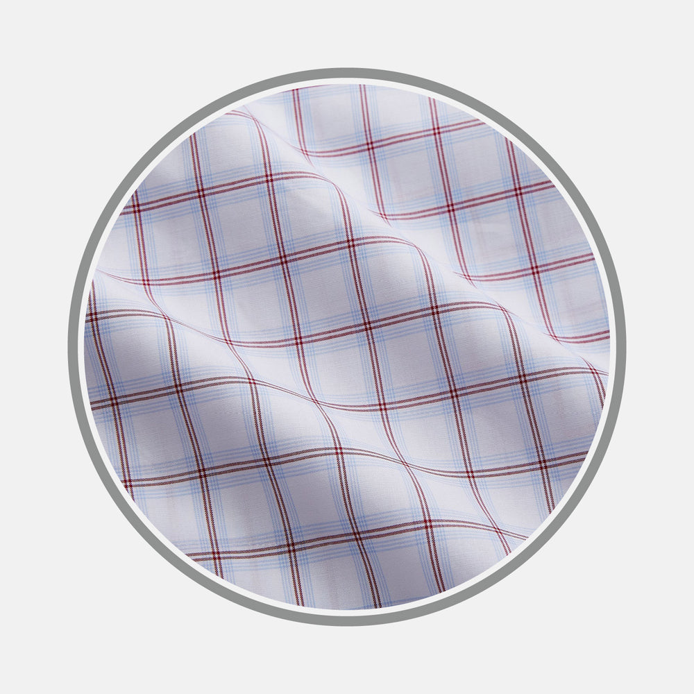 Close-up of Turnbull & Asser Red and Blue Multi Check Cotton Fabric, featuring a wavy texture and plaid pattern, displayed within a circular border.