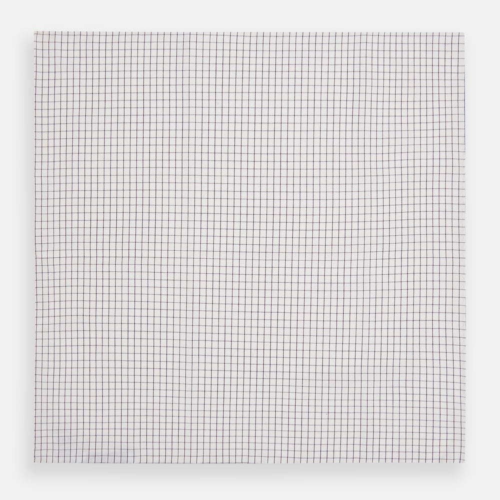 The Turnbull & Asser Hand Rolled Purple Graph Check Handkerchief features a white cloth with evenly spaced thin purple lines forming small squares, neatly laid flat against a white background.