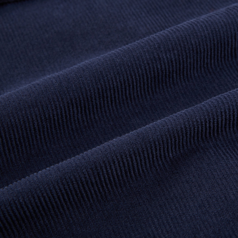 The Turnbull & Asser Light Navy Kingston Corduroy Caban Jacket features a double-breasted stretch cotton corduroy design with black buttons, notched collar, and long buttoned cuffs, displayed on a plain white background.