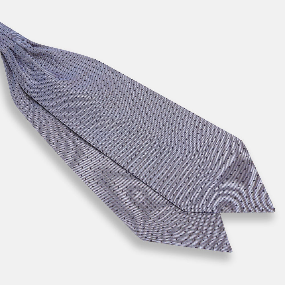 A light gray pocket square with small black polka dots pairs perfectly with the Turnbull & Asser Navy and Light Blue Micro Dot Silk Cravat for a refined, polished formal look.