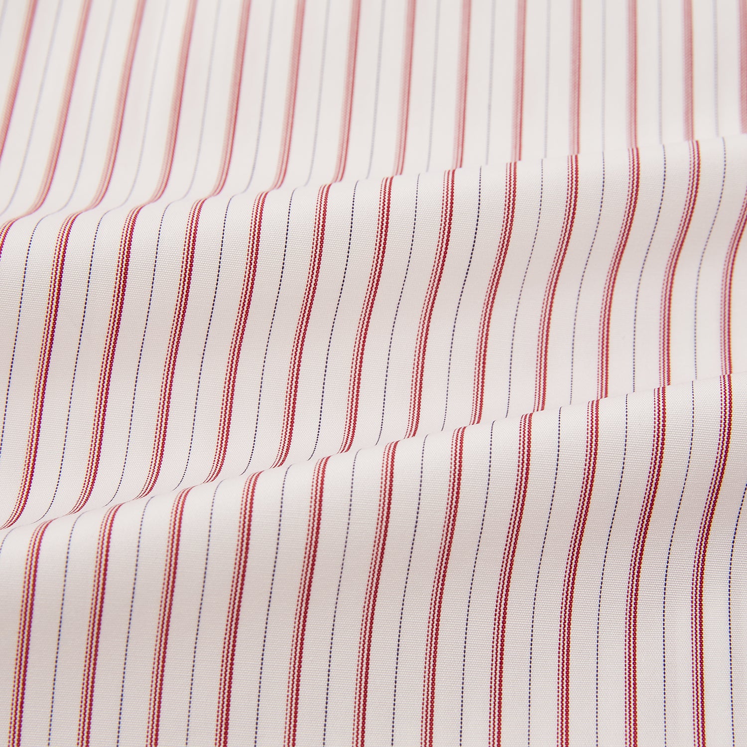 View 6 of product The Red Multi Ticking Stripe Mayfair Shirt by Turnbull & Asser features thin red and blue vertical stripes on white, a T&A collar, long sleeves, and button-up design.