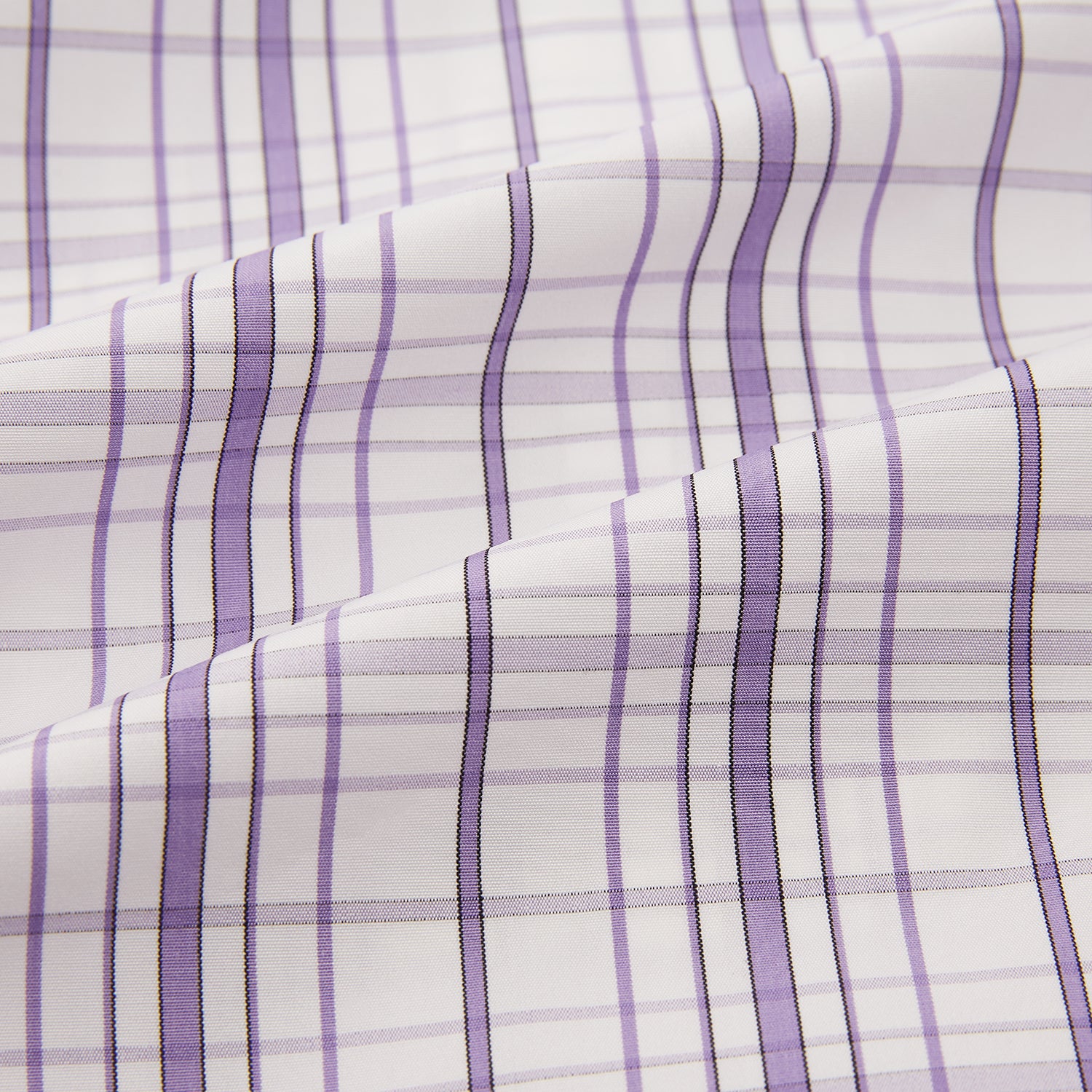 View 6 of product The Turnbull & Asser Purple Plaid Check Mayfair Shirt is a long-sleeve button-down with a pointed T&A collar, featuring a purple and blue plaid pattern on white.