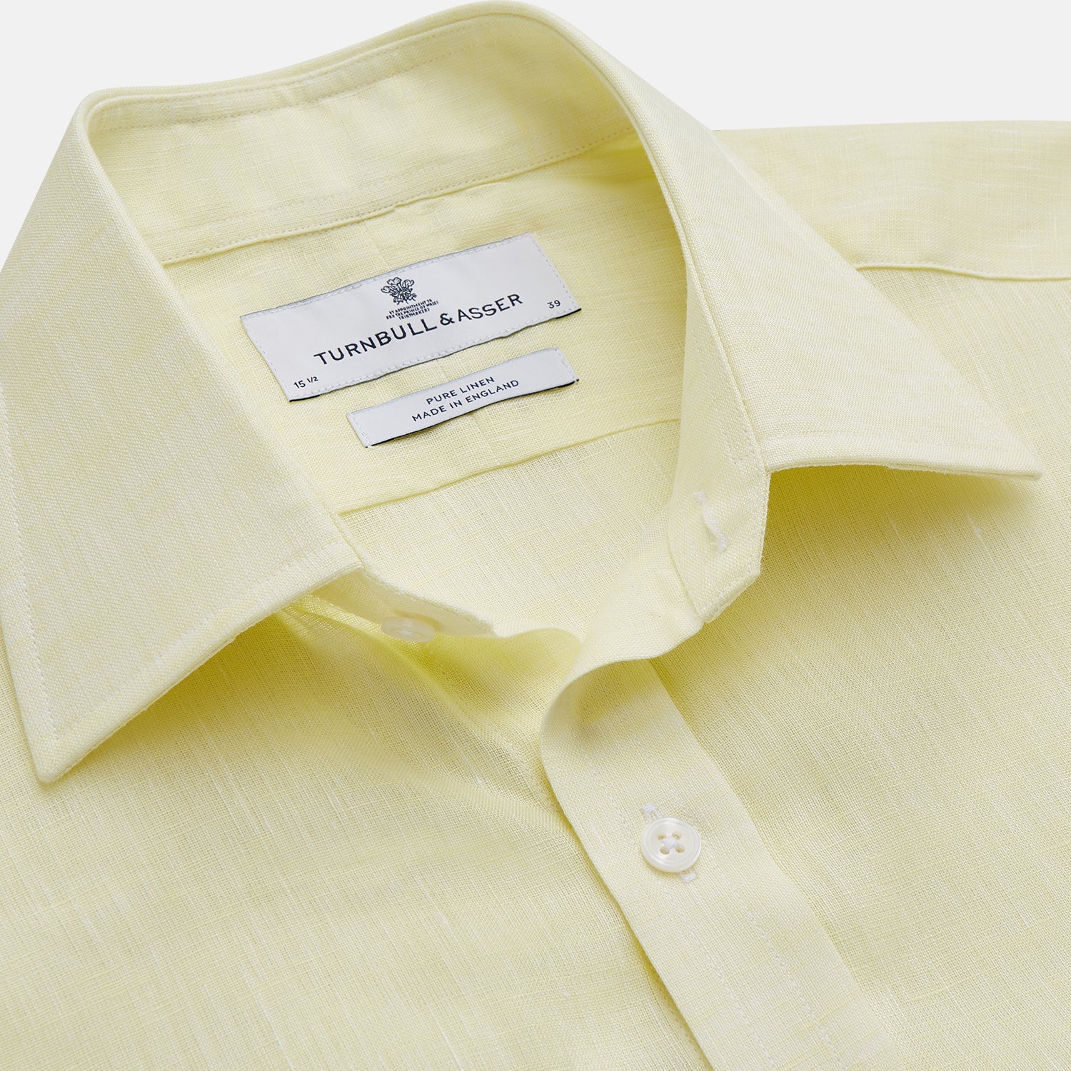 View 2 of product The Turnbull & Asser Yellow Linen Regular Fit Mayfair Shirt is a long-sleeve button-up with a collar and buttoned cuffs, shown laid flat on a white background.