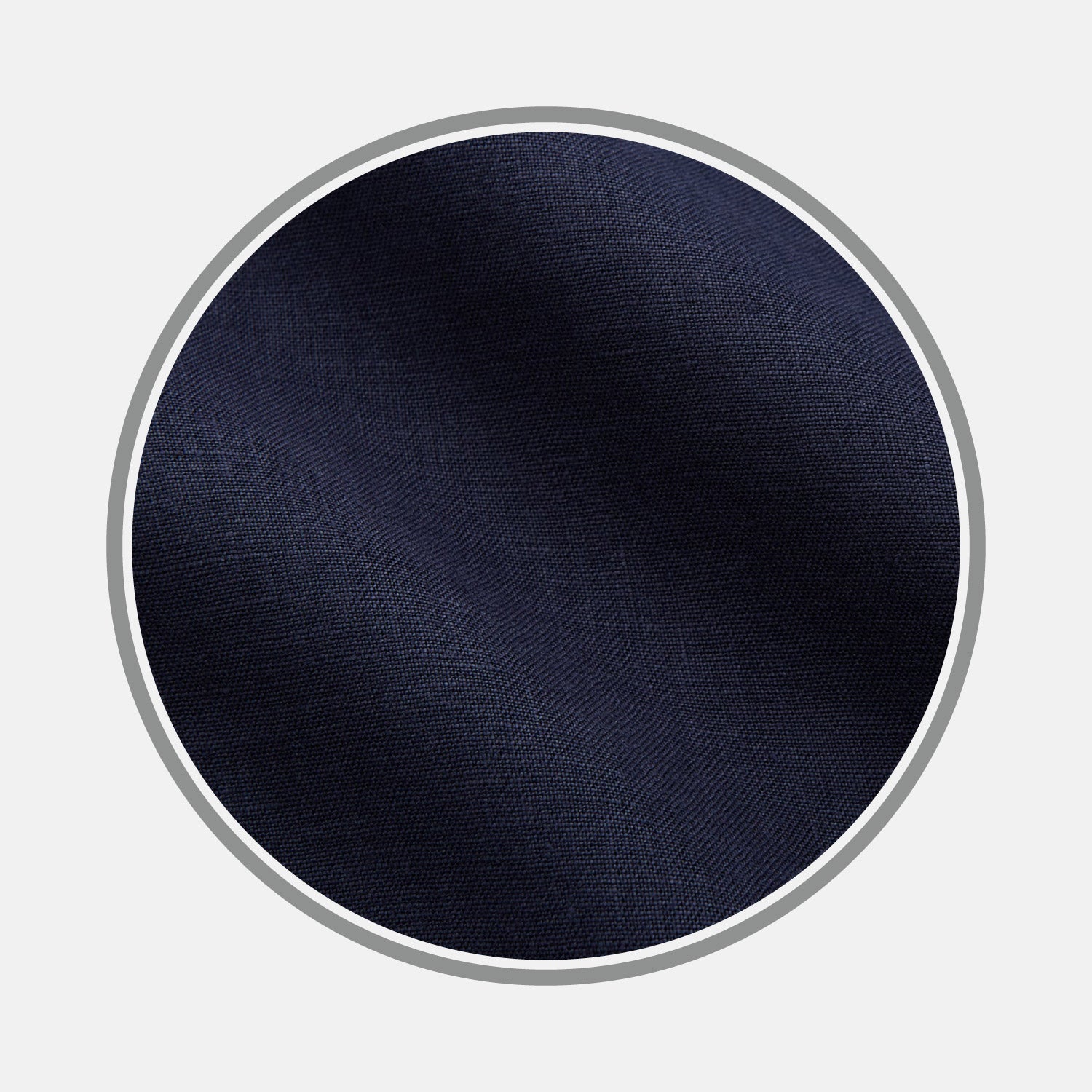 View 1 of product A close-up of Turnbull & Asser's Plain Navy Hemp Cotton Fabric displays its subtle texture within a circular gray-bordered frame on a white background.