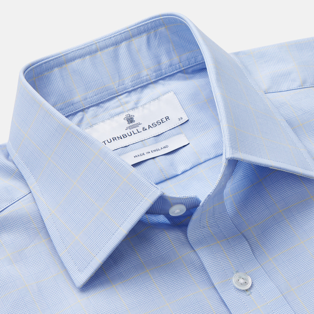A Turnbull & Asser Yellow and Blue Prince of Wales Check Mayfair Shirt with white buttons and a classic collar, laid flat on a white background.