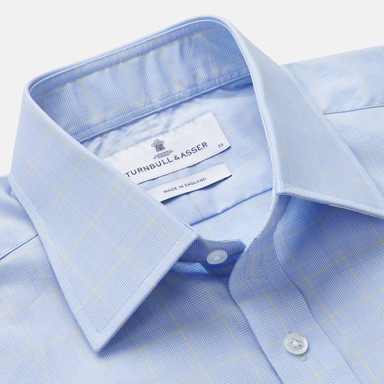 View 4 of product A Turnbull & Asser Yellow and Blue Prince of Wales Check Mayfair Shirt with white buttons and a classic collar, laid flat on a white background.