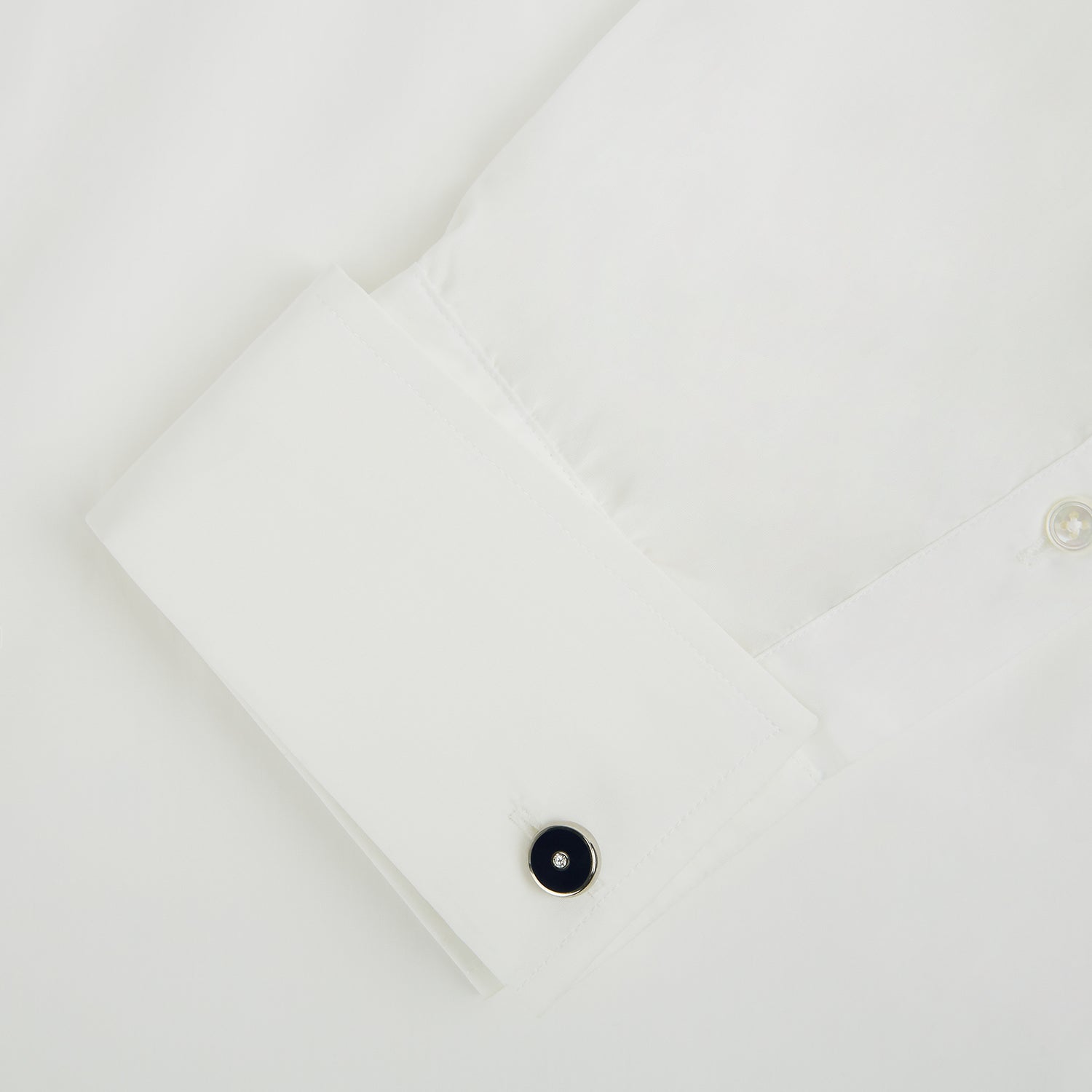 View 3 of product Turnbull & Asser's Navy Gemstone Circle Cufflinks feature round sterling silver with black enamel centers and a clear gemstone, shown on a white background.