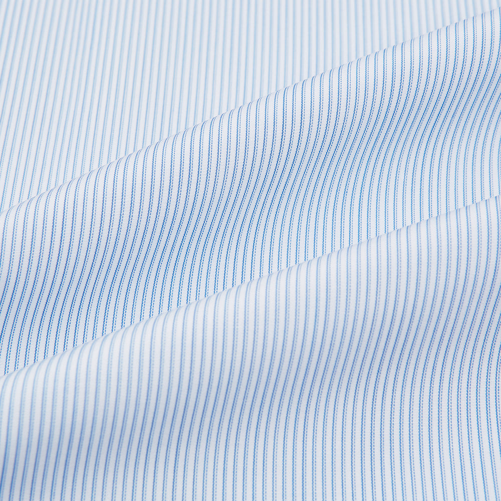 The Turnbull & Asser Sky Blue Hairline Multi Stripe Mayfair Shirt features Italian cotton, long sleeves, a classic collar, white buttons, and a subtle stripe pattern, shown on a plain white background.