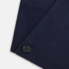 View 4 of product The Turnbull & Asser Navy Silk and Cotton Neck Warmer features a dark navy blue textured fabric and a single black button, shown against a plain light gray background.
