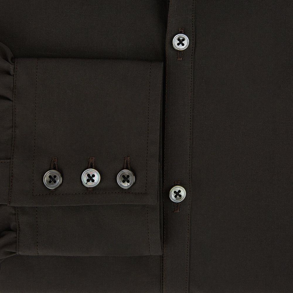 A brown Windsor long-sleeve button-up shirt by Turnbull & Asser with a classic collar, buttoned cuffs, and a straight hem, laid flat on a white background—showcasing refined British craftsmanship.