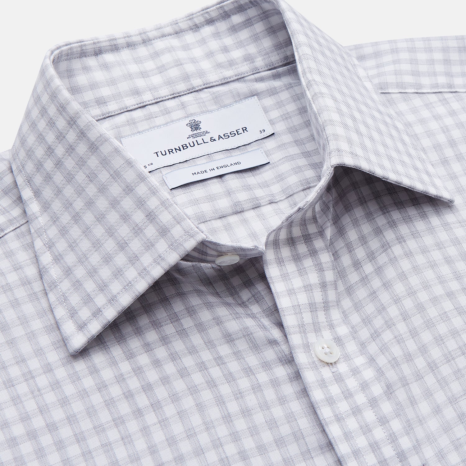 View 2 of product The Grey Check Cotton Melange Regular Fit Mayfair Shirt by Turnbull & Asser features a light gray and white small checkered pattern, a collar, and front buttons, shown against a white background.
