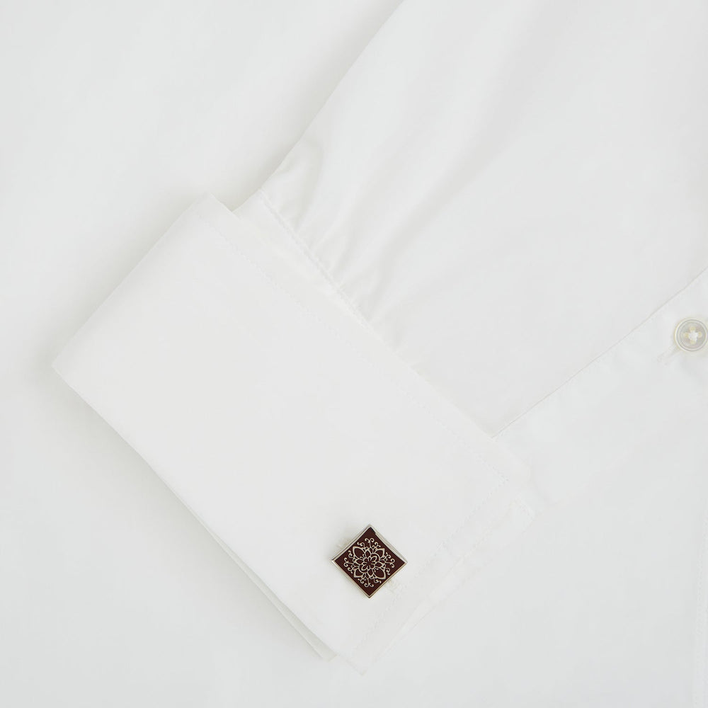 Turnbull & Asser Burgundy Floral Square Cufflinks feature a reddish-brown enamel face with an intricate white mandala pattern at the center, all set in elegant sterling silver.