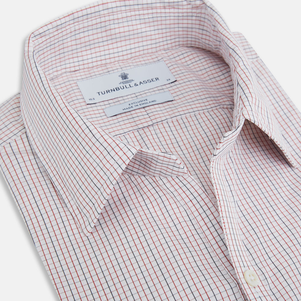 The Turnbull & Asser Red and Navy Check Windsor Shirt features a pointed collar and cuffed long sleeves, highlighting British craftsmanship. Displayed flat on a white background.