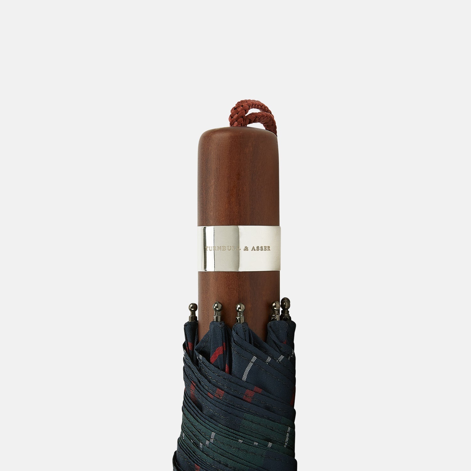 View 3 of product The Colquhoun Tartan Telescopic Umbrella by Turnbull & Asser features a green, blue, and red plaid canopy, silver metal shaft, and brown maple handle with wrist strap. Shown fully open against a plain white background.