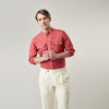 View 3 of product The Turnbull & Asser Plain Red Linen Weekend Fit Shirt with Stand Collar features long sleeves, a button-up front, and two buttoned-flap chest pockets. It is shown neatly laid flat on a plain light background.
