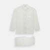 View 1 of product The Turnbull & Asser Cream Silk Pyjama Set, shown laid flat on a white background, features a long-sleeve button-up top with a chest pocket and matching pants with an elastic drawstring waist—ideal for comfortable loungewear.