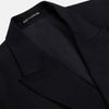 View 2 of product The Classic Navy Wool Blazer by Turnbull & Asser is a nautical double-breasted jacket with gold buttons, peaked lapels, three front pockets on one side, one on the other, and four gold buttons per cuff, shown against a white background.