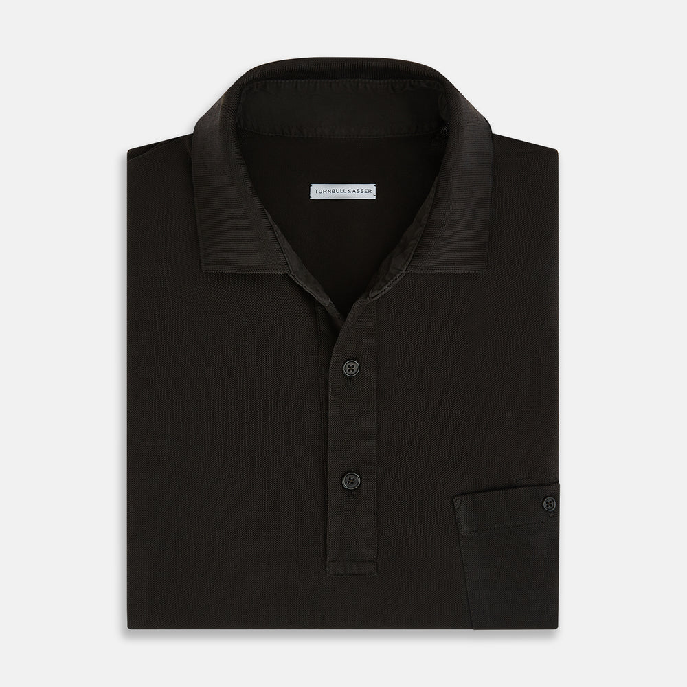 A brown cotton jersey polo shirt by Turnbull & Asser with short sleeves, a collar, three buttons, and a buttoned chest pocket, laid flat on a white background.