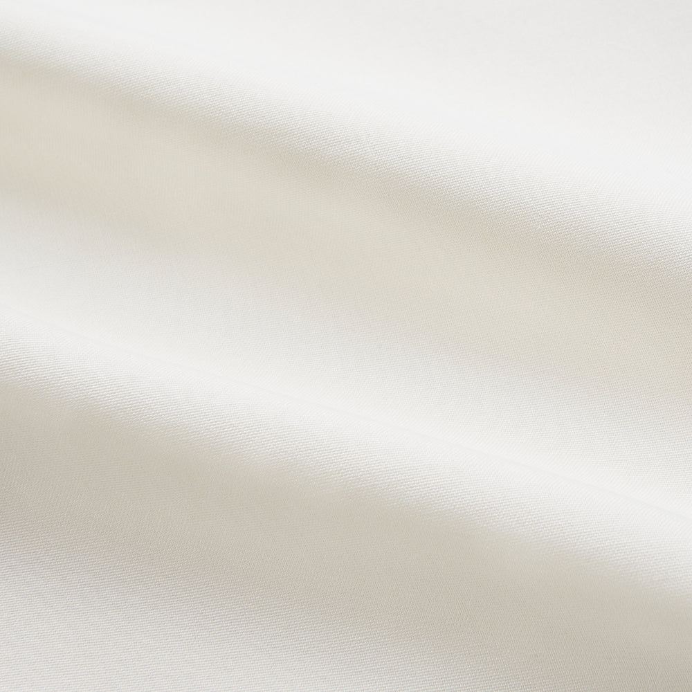 The Cream Silk Whitby Shirt by Turnbull & Asser features a pointed collar, buttoned front and cuffs, and long sleeves, shown in Whitby Fit and laid flat on a white background.