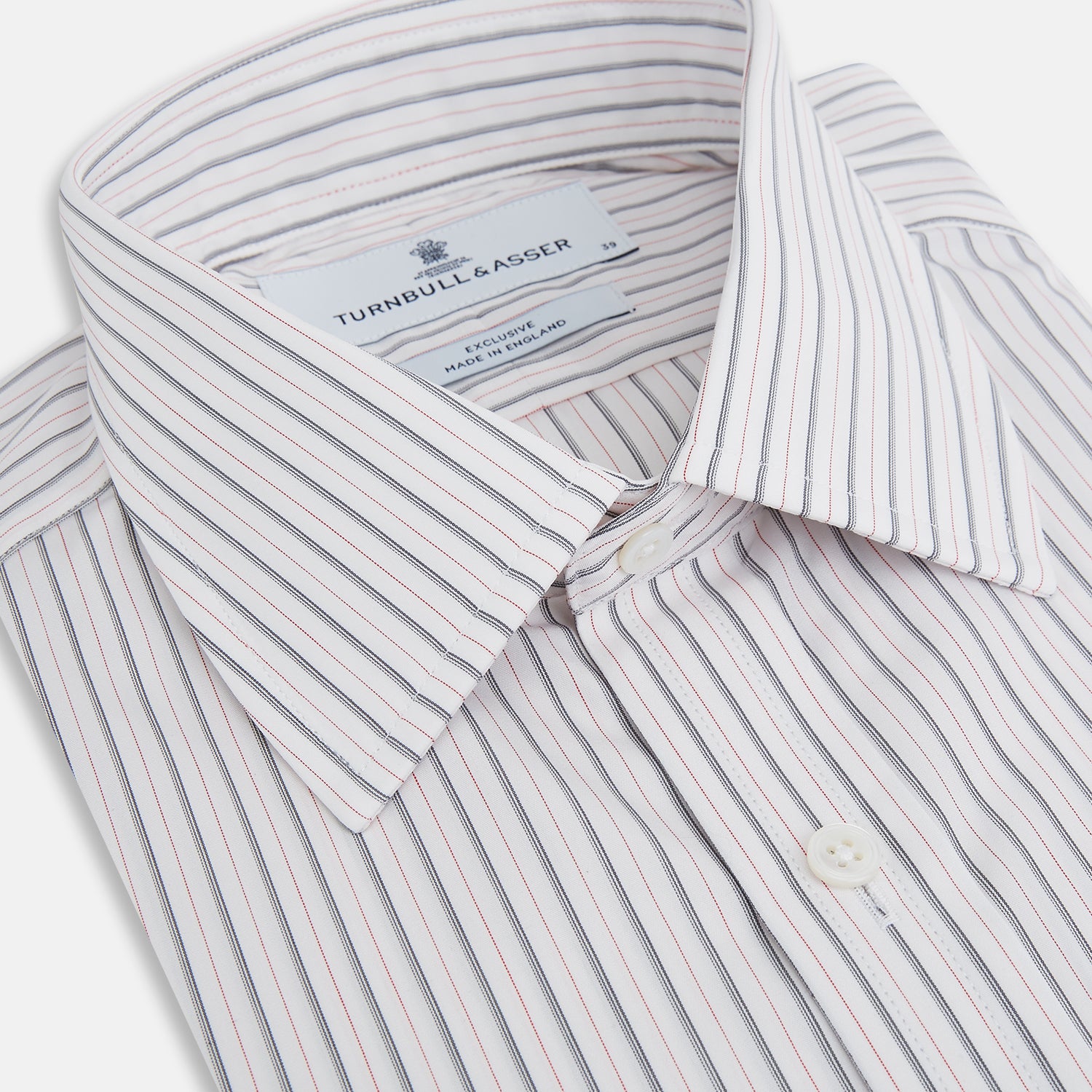 View 2 of product The Turnbull & Asser Midnight Blue and Red Ticking Stripe Mayfair Shirt features long sleeves, a pointed collar, buttoned cuffs, and fine Italian cotton—an essential men's wardrobe piece shown on a plain white background.