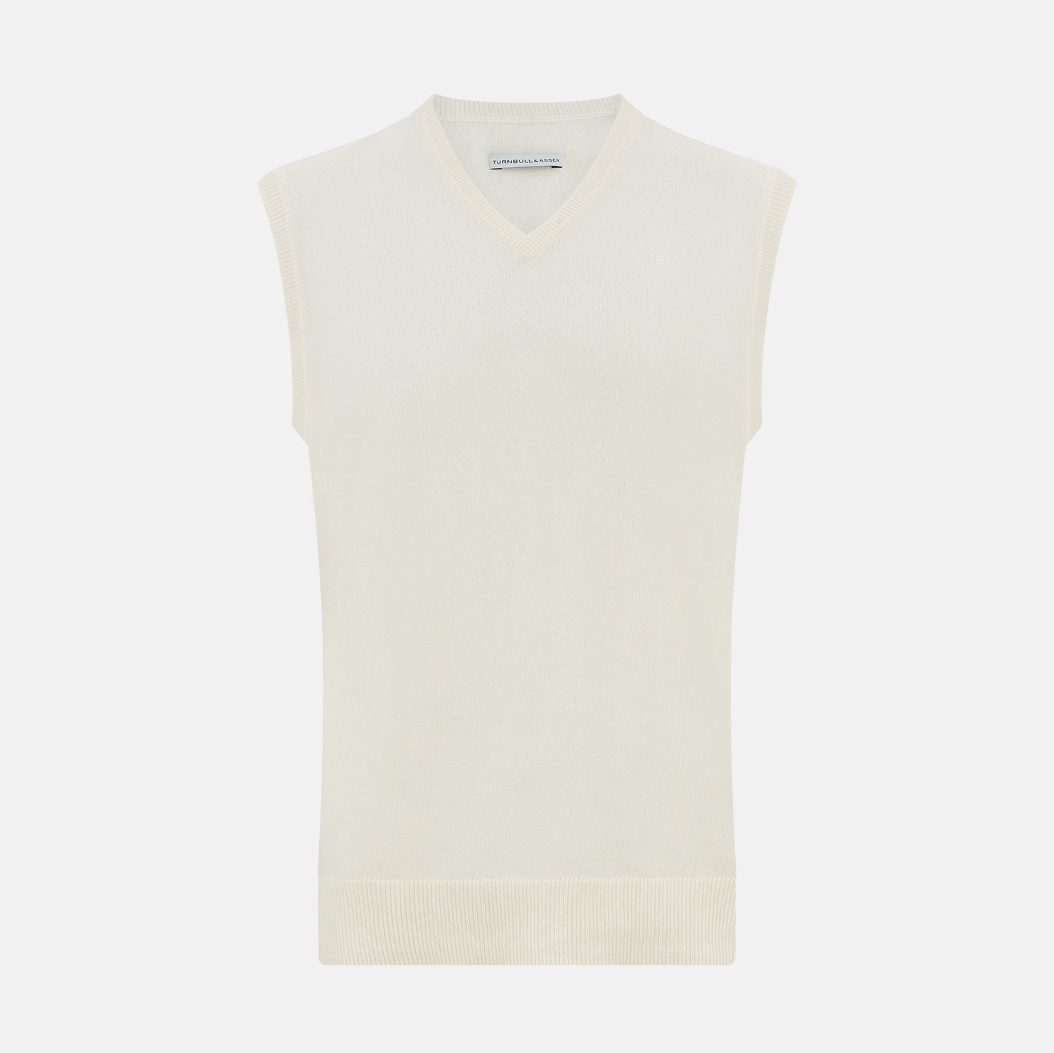 View 1 of product The Turnbull & Asser White Cashmere V-neck Vest is a sleeveless ivory knit with ribbed trim, ideal for layering in cooler weather, shown against a plain white background.