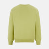 View 3 of product The Turnbull & Asser Melon Green Cashmere V-Neck Jumper features long sleeves with ribbed cuffs and hem, shown against a plain white background.