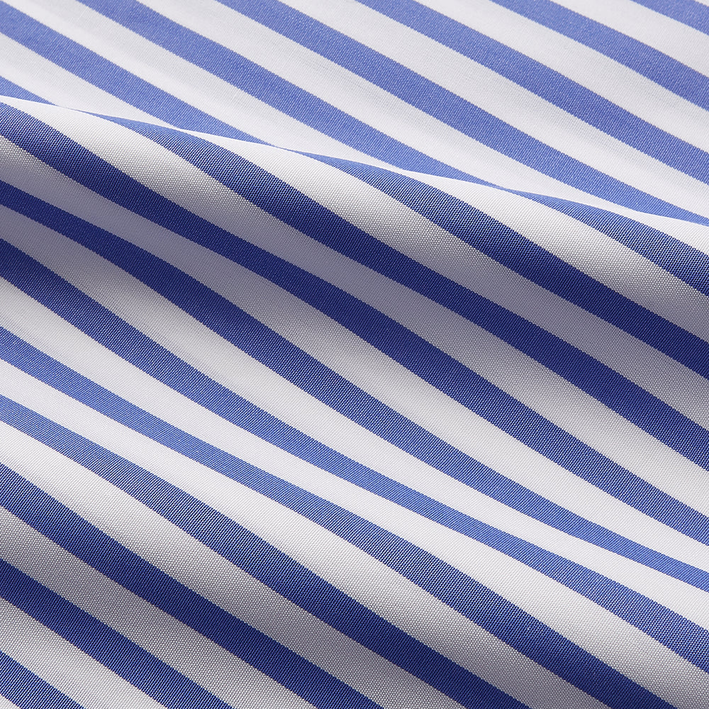 The Turnbull & Asser Pale Blue Candy Stripe Cotton Marlene Shirt is an oversized women's collared shirt with long sleeves, buttoned cuffs, and vertical blue and white stripes, shown laid flat on a white background.