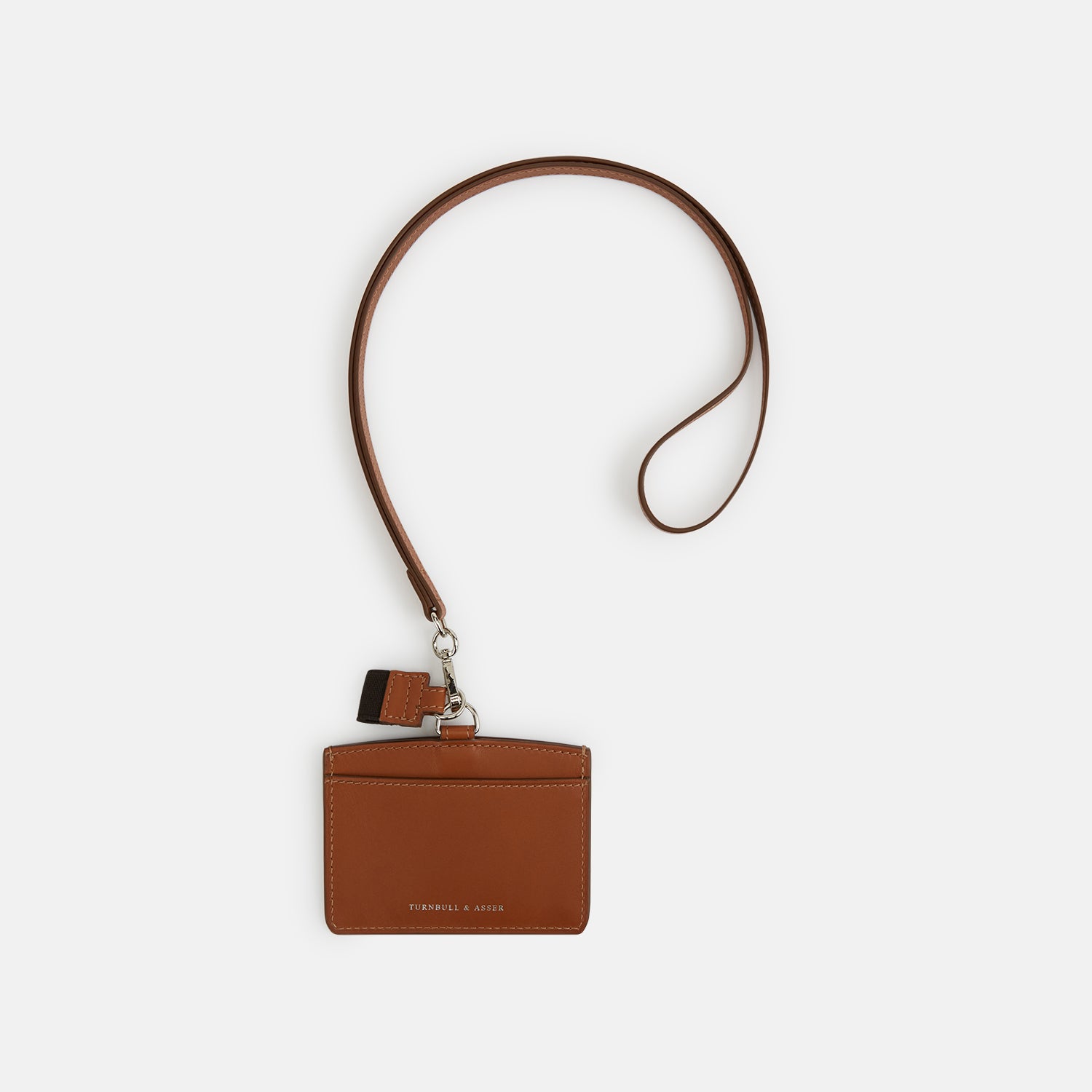 View 1 of product The Turnbull & Asser Camel ID Card Holder, shown on a white background, features Italian leather in brown with a matching lanyard, silver clasp, keychain tag, and "Turnbull & Asser" embossed in gold lettering.