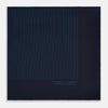 View 4 of product The Navy and Blue Stripe Silk Pocket Square by Turnbull & Asser features vertical blue pinstripes, is crafted from silk with hand-rolled edges, and is finished with the brand's logo printed in blue at the lower right corner.