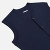 View 2 of product The Turnbull & Asser Navy Fine Merino V-Neck Sleeveless Cardigan features a front button closure, ribbed hem, and two pockets—sophisticated knitwear shown on a plain white background.
