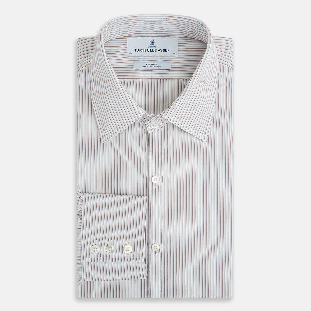 The Coffee and Grey Shadow Pinstripe Westminster Shirt by Turnbull & Asser features thin white and gray stripes, a long sleeve, button-down style, and signature collar, all reflecting classic British craftsmanship.