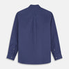 View 7 of product The Blue Piece Dyed Weekend Fit Suffolk Shirt by Turnbull & Asser features a button-down Dorset collar, chest pocket, white buttons, and long sleeves in classic navy, laid flat against a white background.