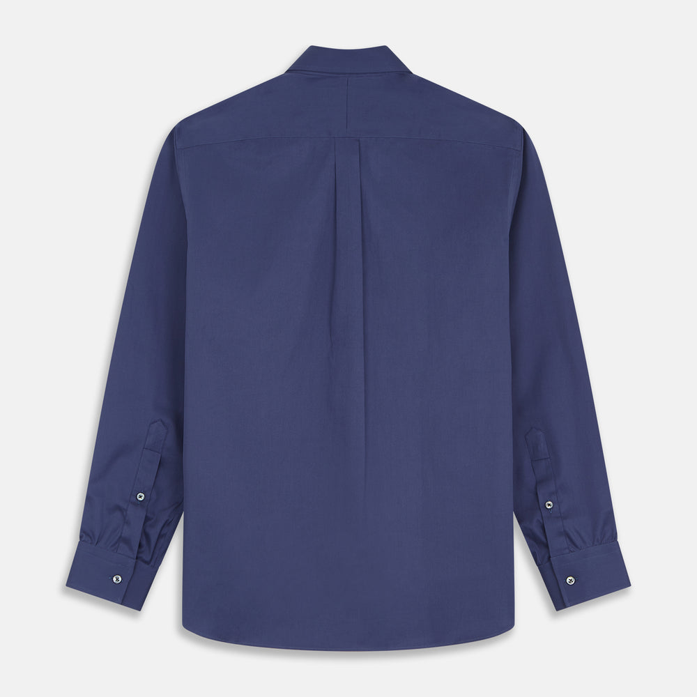The Blue Piece Dyed Weekend Fit Suffolk Shirt by Turnbull & Asser features a button-down Dorset collar, chest pocket, white buttons, and long sleeves in classic navy, laid flat against a white background.