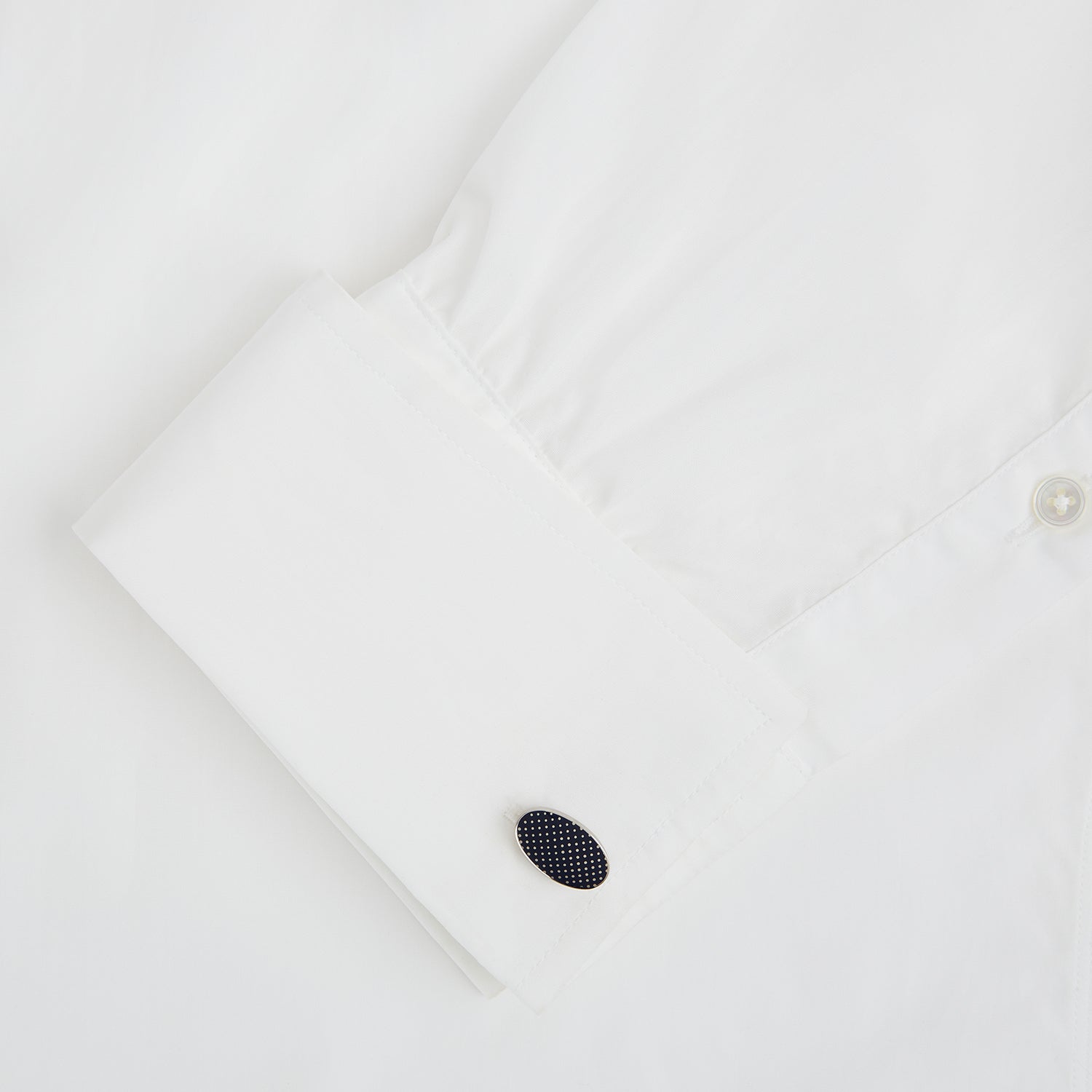 View 3 of product Turnbull & Asser's Navy Dotted Oval Cufflinks feature a silver finish and small white dots—ideal for adding a refined touch to any formal outfit. Shown here against a white background.